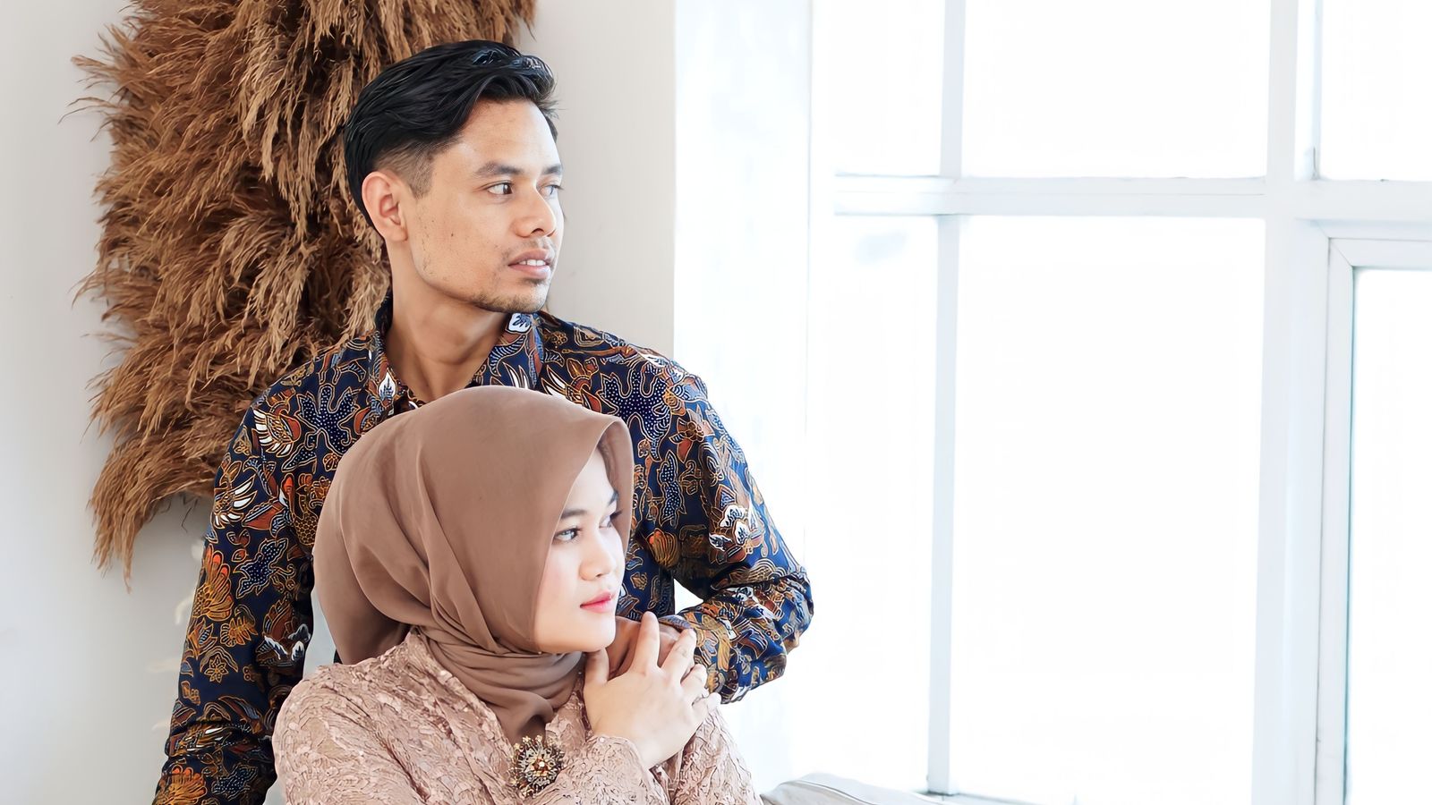 Asian couple sitting by window, traditional clothing
