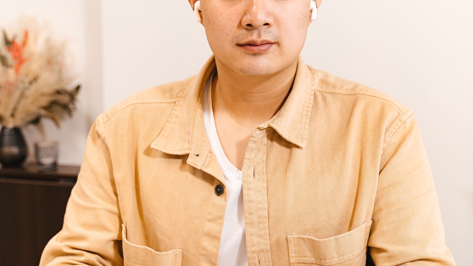 Asian male professional working at desk with charts