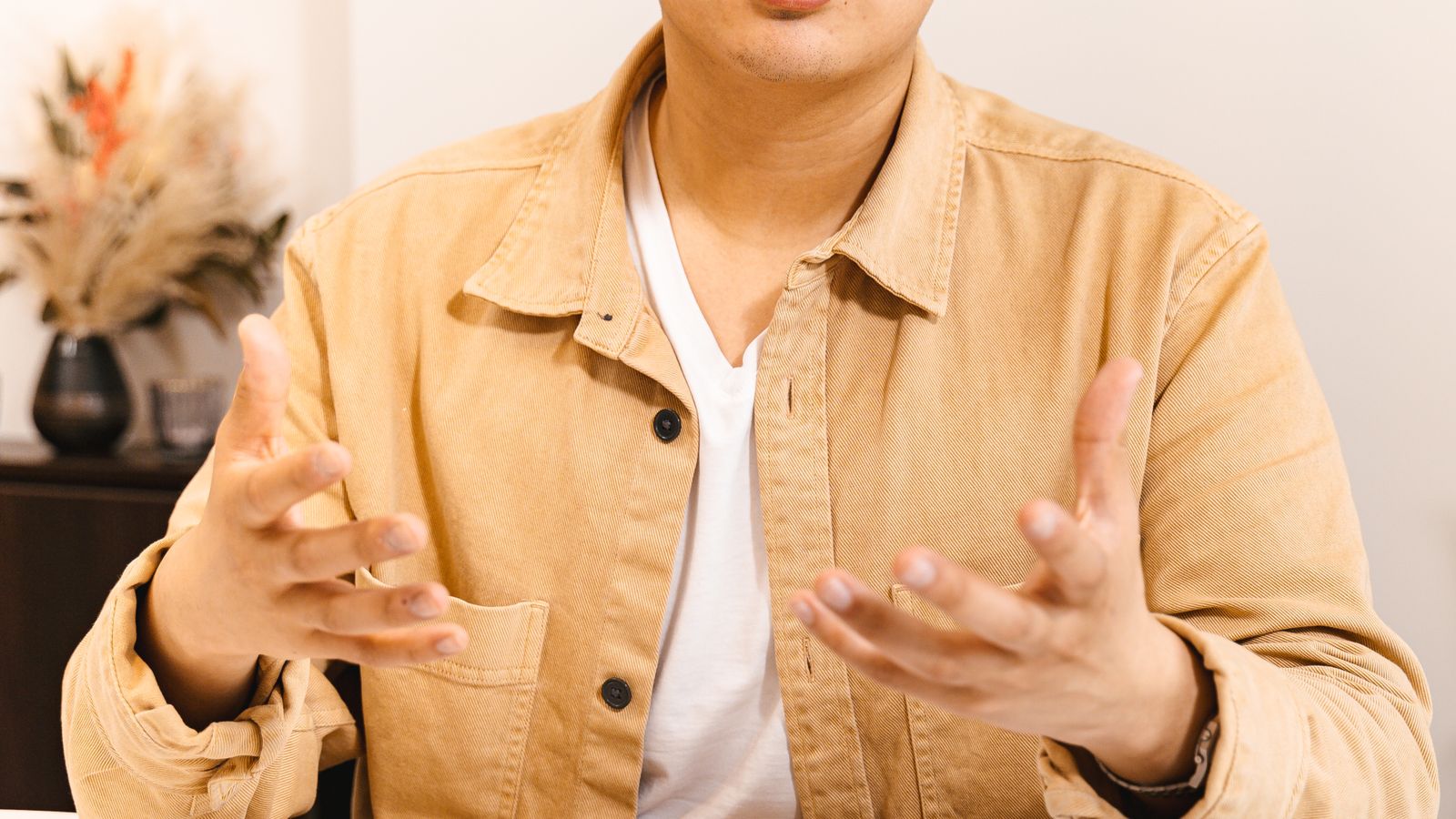 Confident Asian young man presenting business ideas, desk