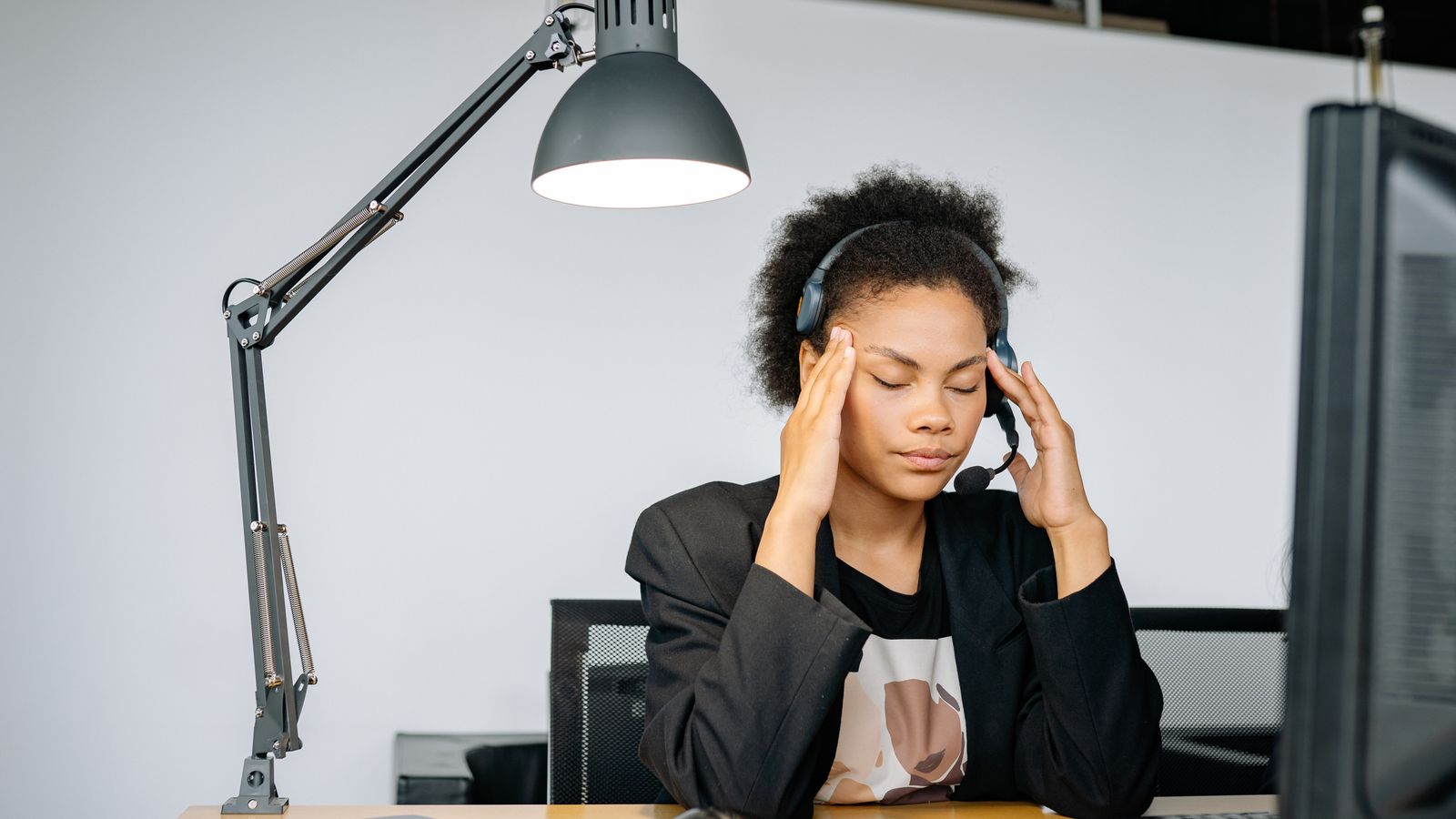 Exhausted call center agent with headset, tired from work
