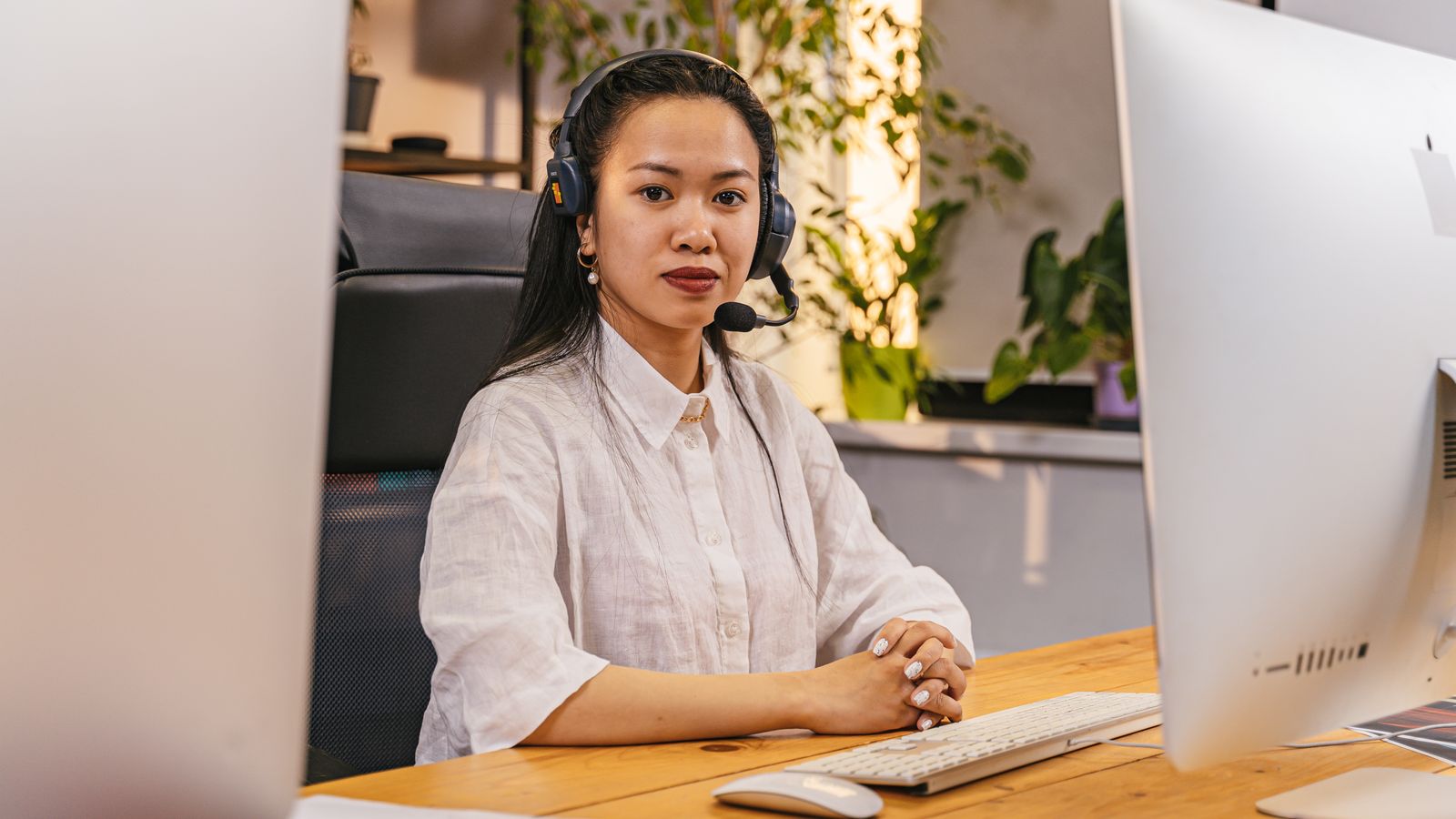 Businesswoman wearing headset working at computer