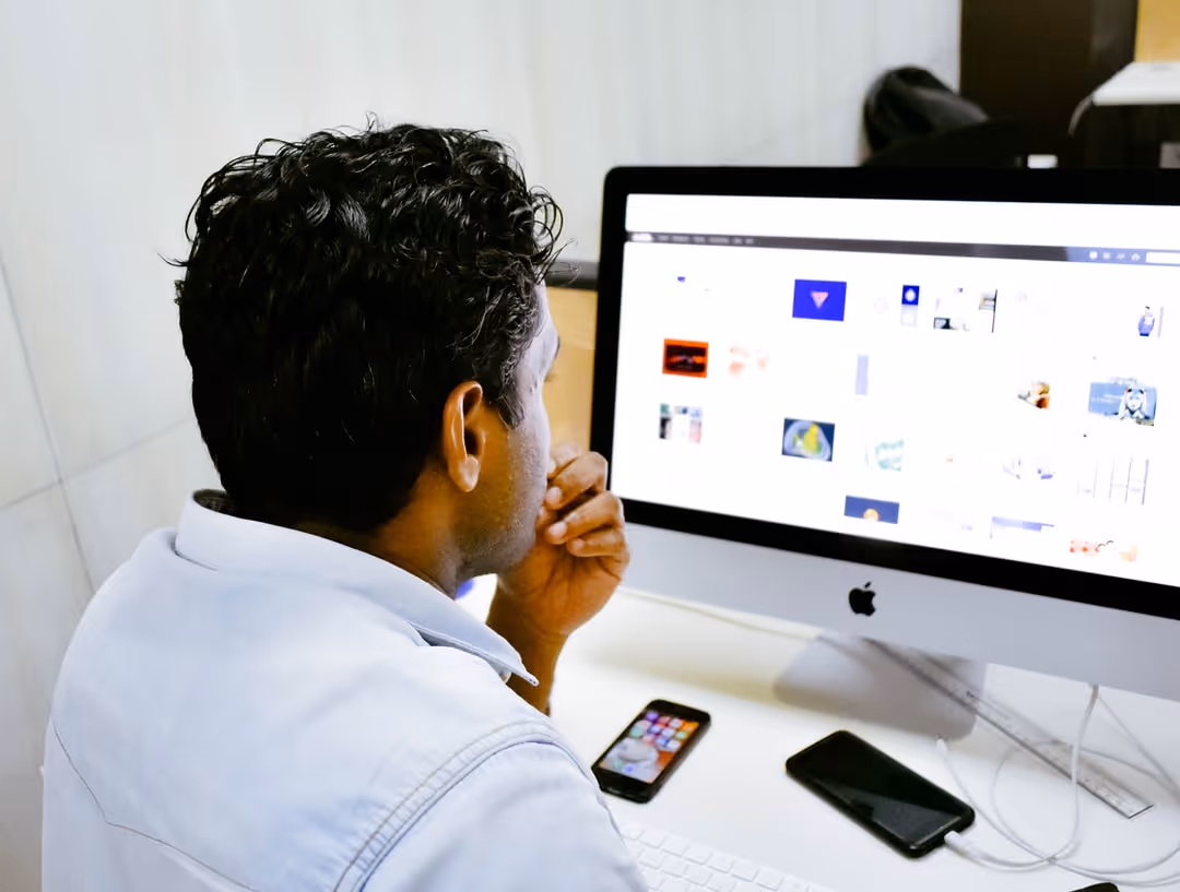 Person looking at computer screen with various images on screen