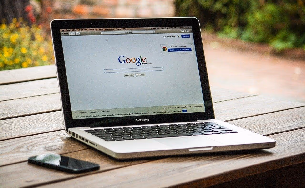 laoptop on table outside with google homepage displayed
