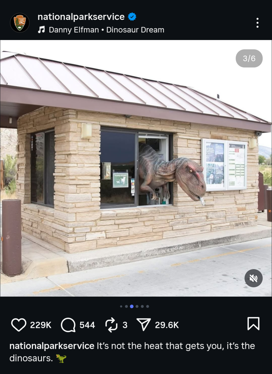 A dinosaur prop humorously placed at a park entrance booth, used by the National Park Service for real-time marketing on social media.