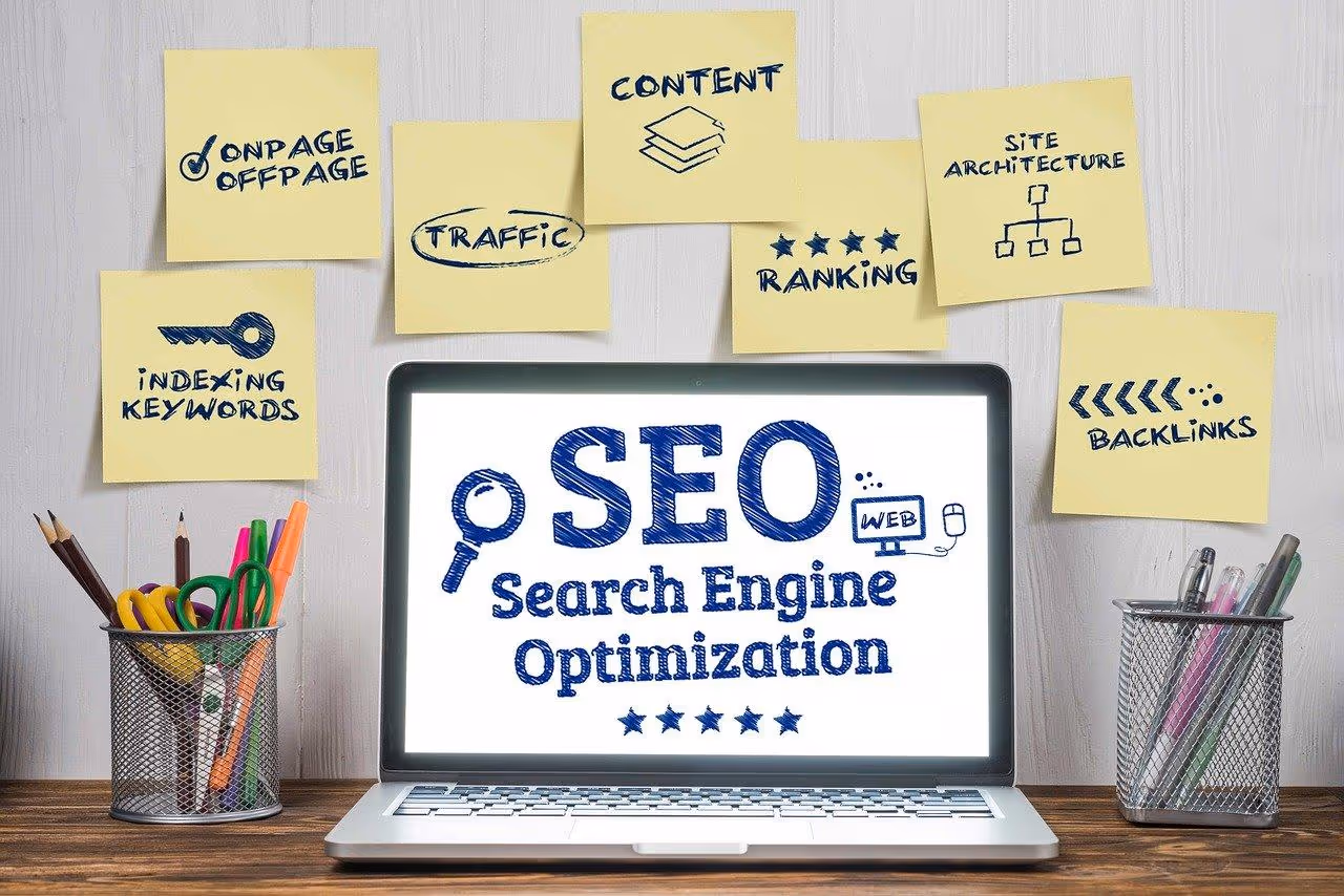 A laptop sits open with SEO on the screen surrounded by sticky notes regarding SEO best praactices