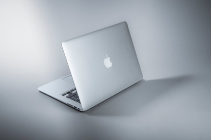 Minimalist Apple laptop showcasing brand attributes of innovation, simplicity, and premium quality