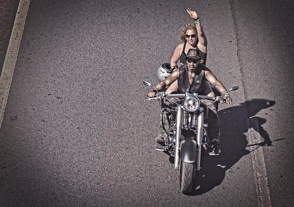Man and woman riding a motorcycle symbolizing brand attributes of freedom, adventure, and rugged individuality