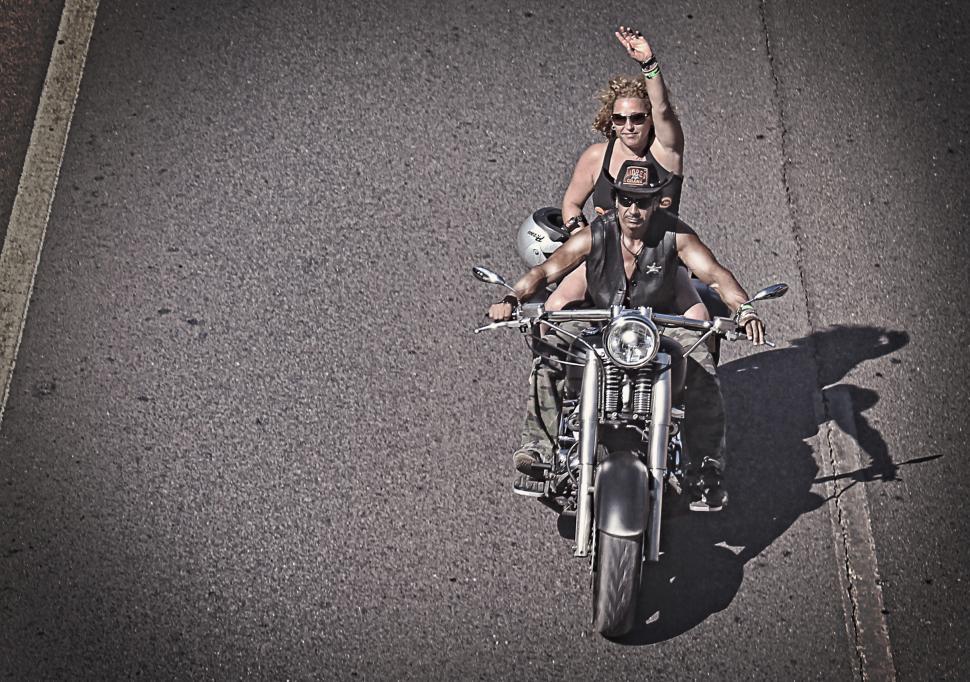 Man and woman riding a motorcycle symbolizing brand attributes of freedom, adventure, and rugged individuality