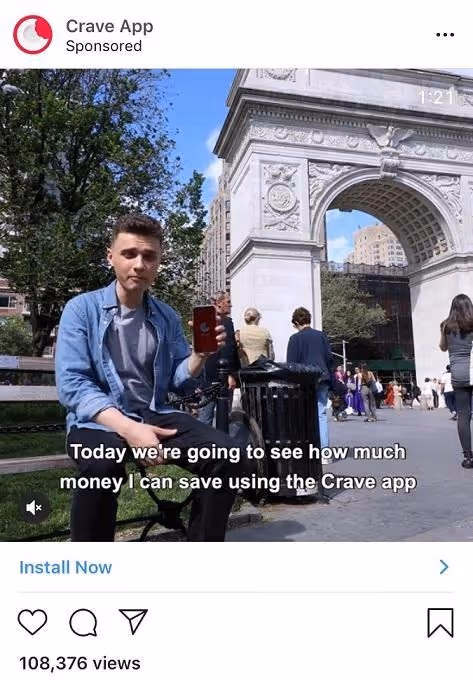 Man in city park shows how to save money using the Crave app.