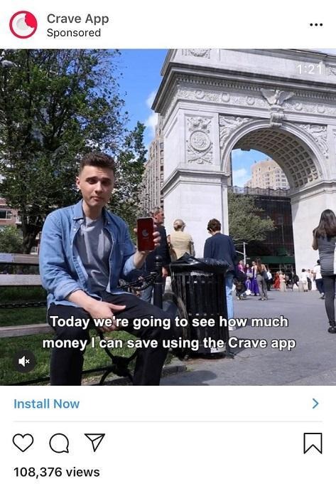 Man in city park shows how to save money using the Crave app.