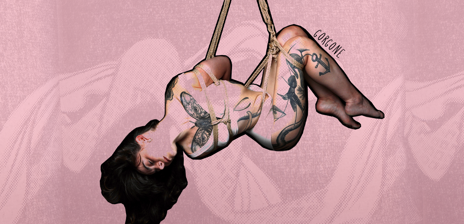 Tattooed woman suspended with a torsion in shibari ropes against pink textured background.