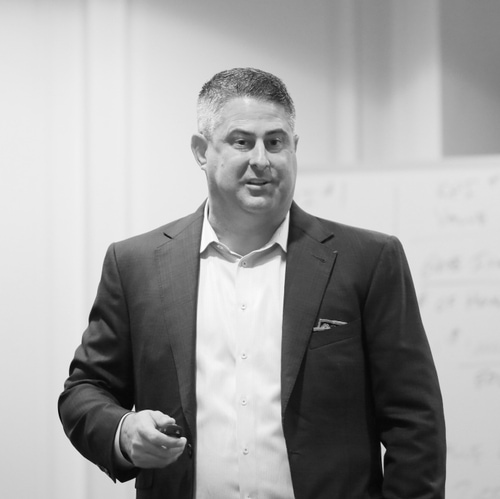 Male advisor in a suit presenting at a training event
