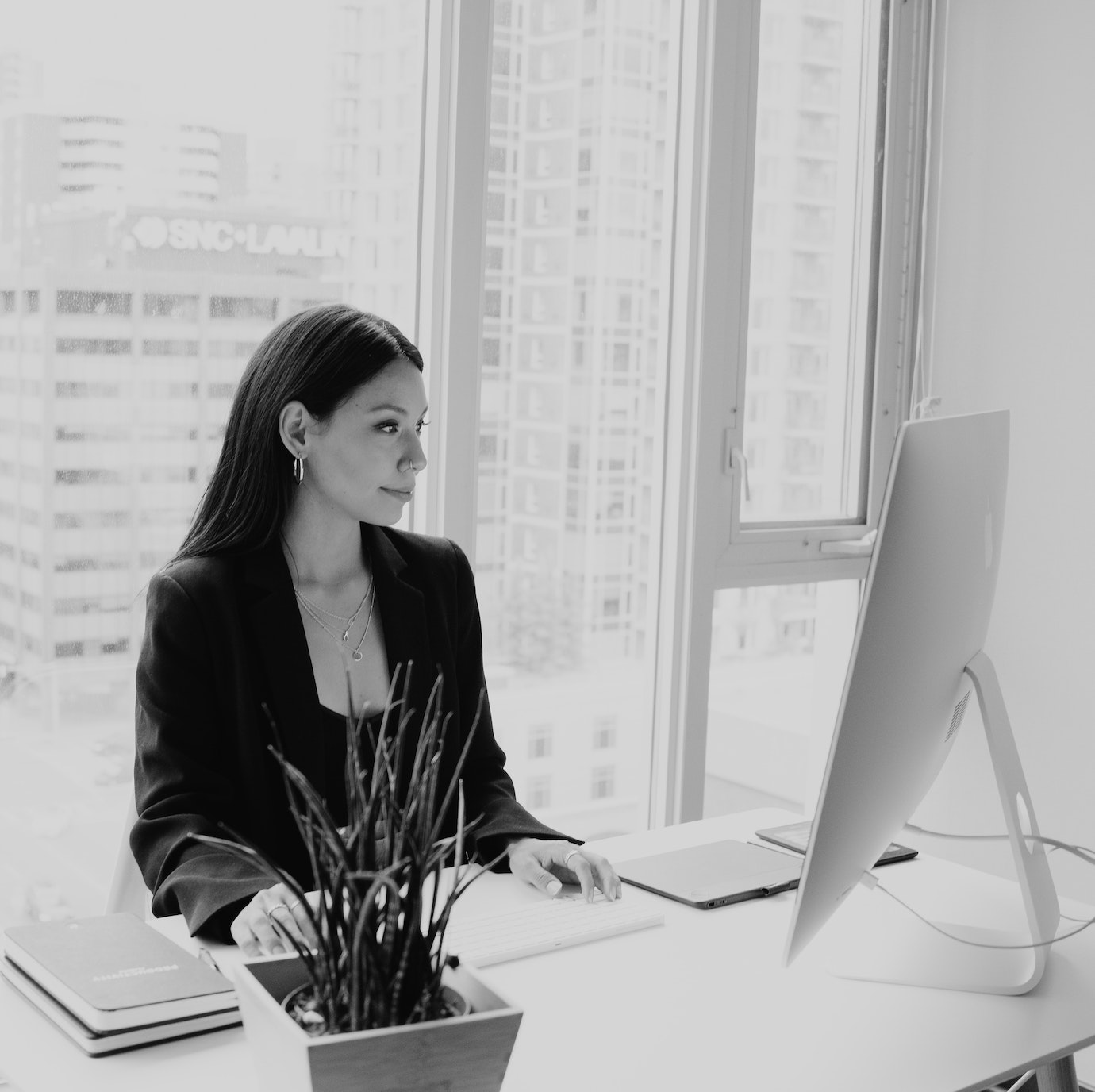 Professional business woman in high rise building working on a computer