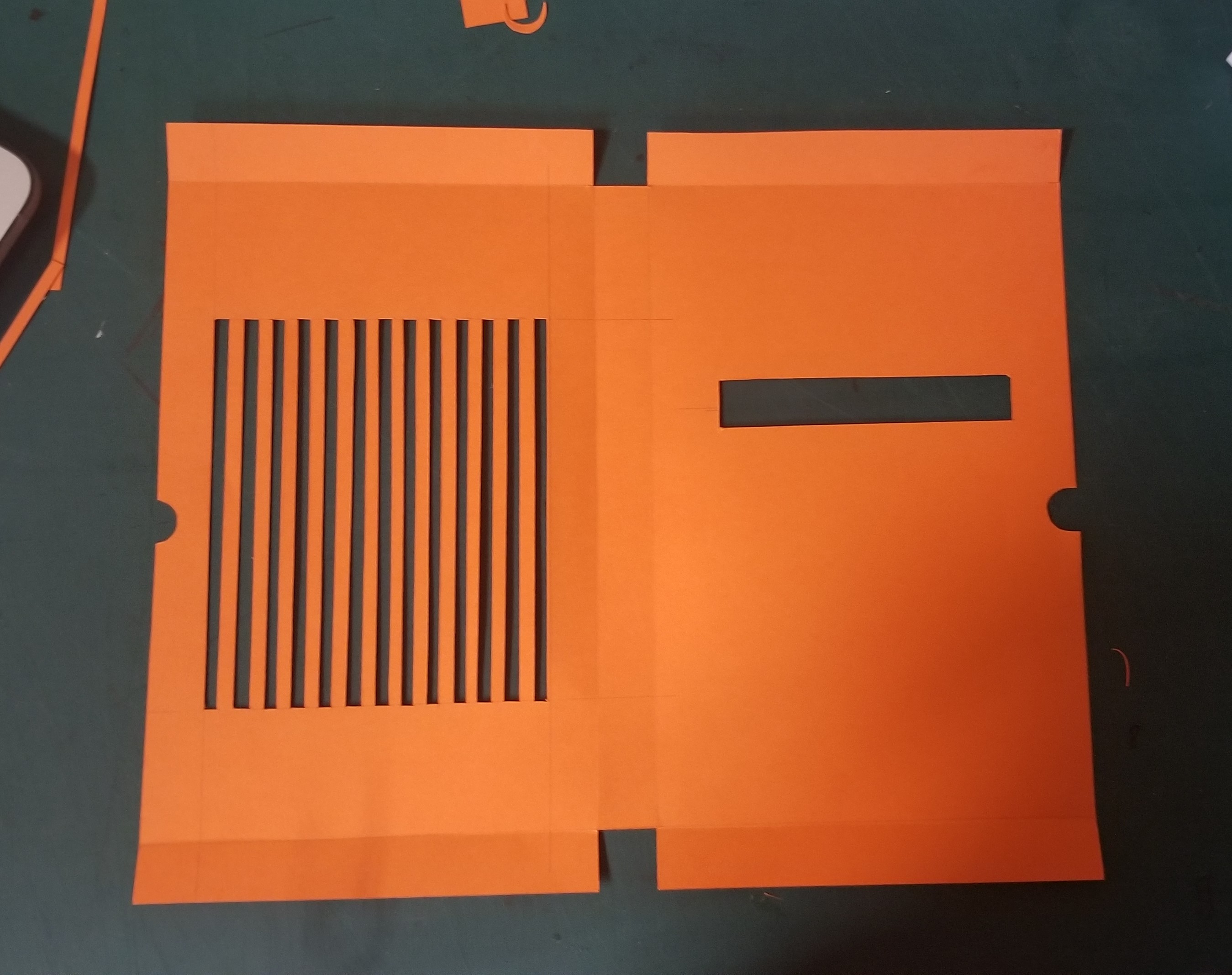 A cut book sleeve laid out flat on a table