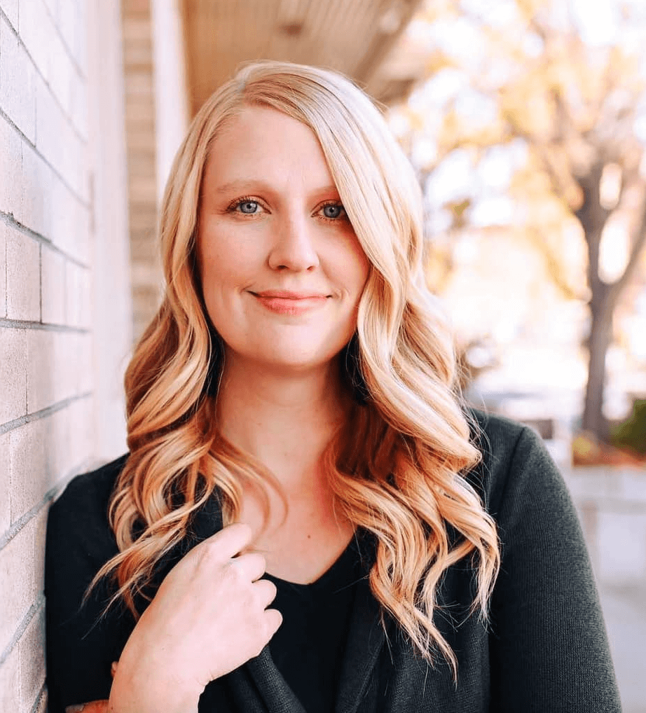 elise williams of emarie photography smiles at the camera outsides
