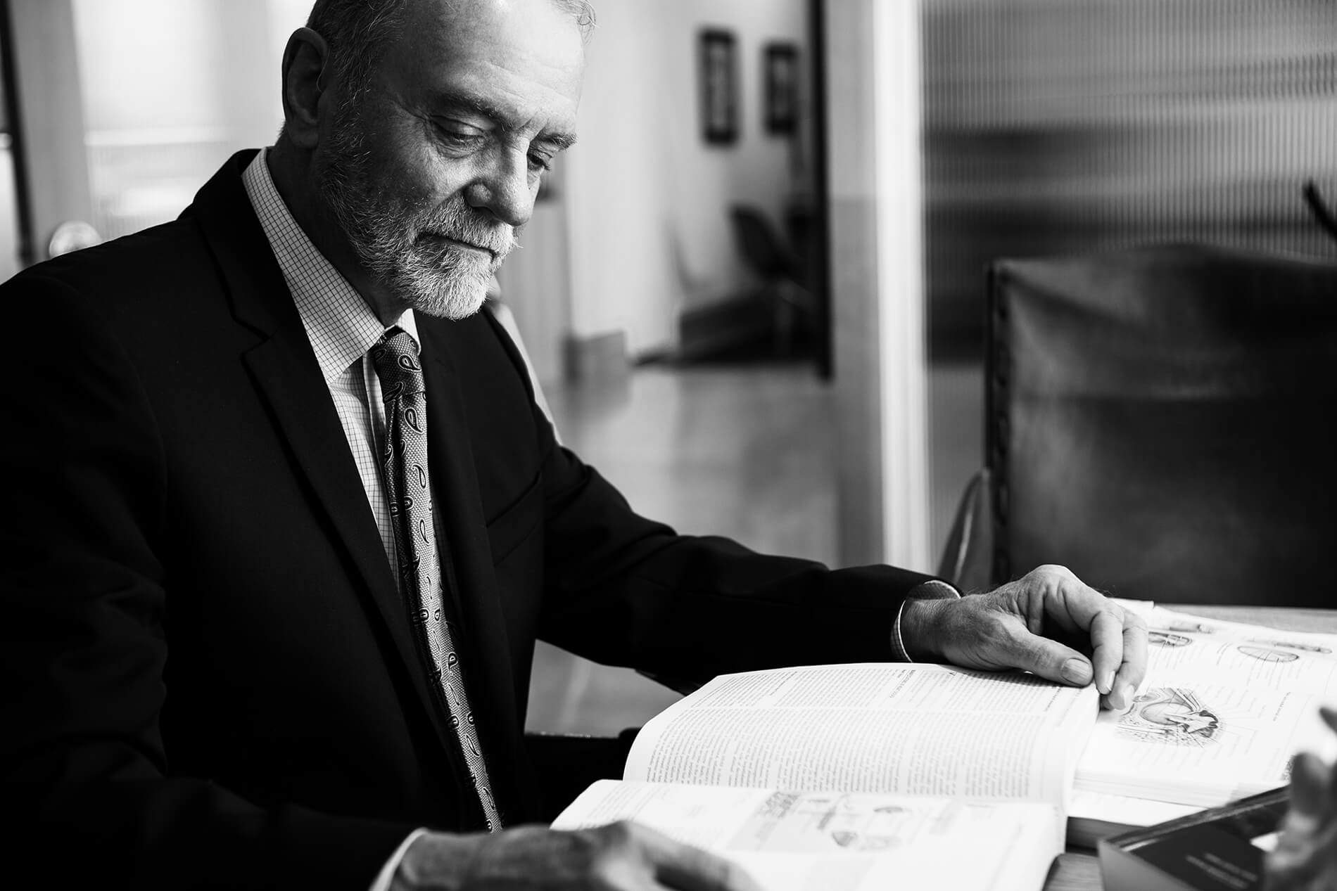 Distinguished man in suit works at desk business photography