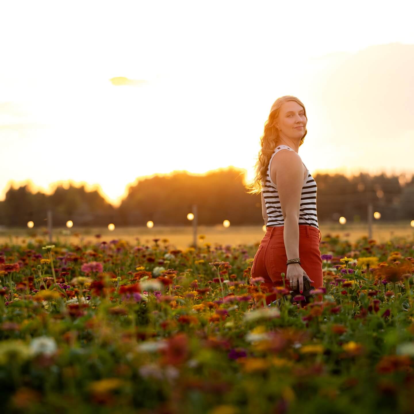 emarie photography owner elise williams smiles in a field
