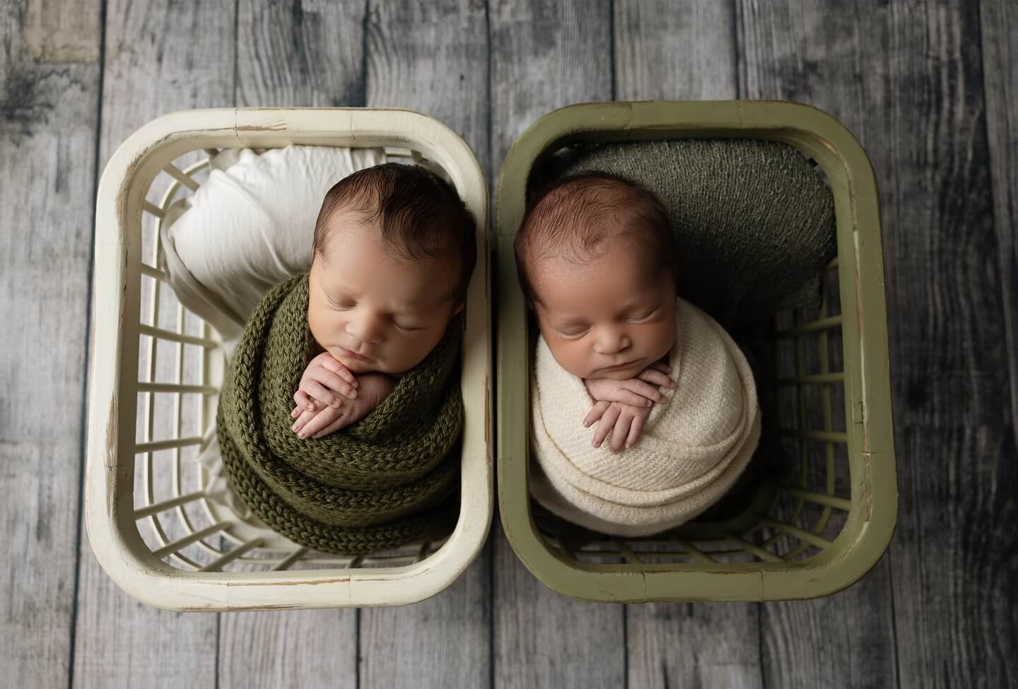 twin babies sleep in brown baskets in emarie photography studio billings mt