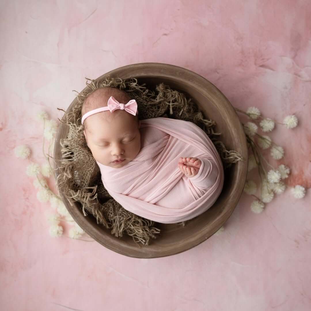 baby girl sleeps in bowl with cute toes sticking out newborn photography billings mt