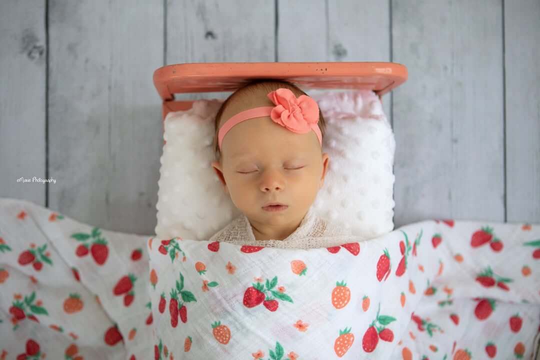 newborn sleeps in tiny bed in emarie photogrpahy studio billings mt