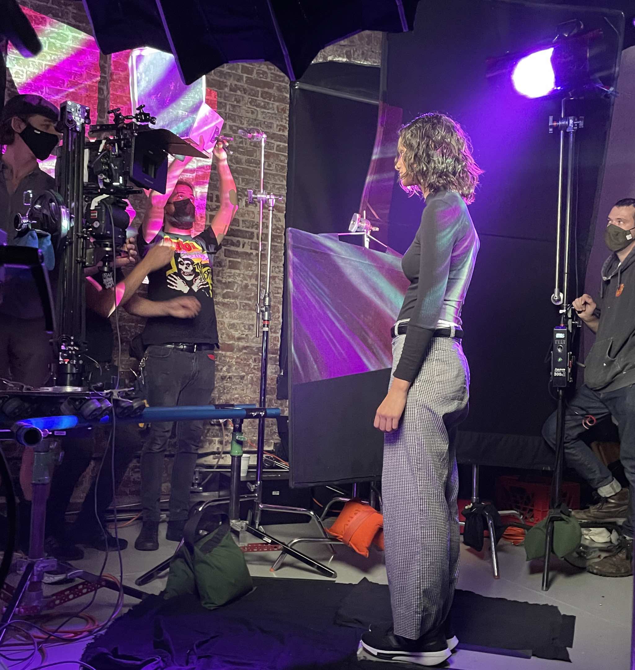 Crew lighting a performer on set