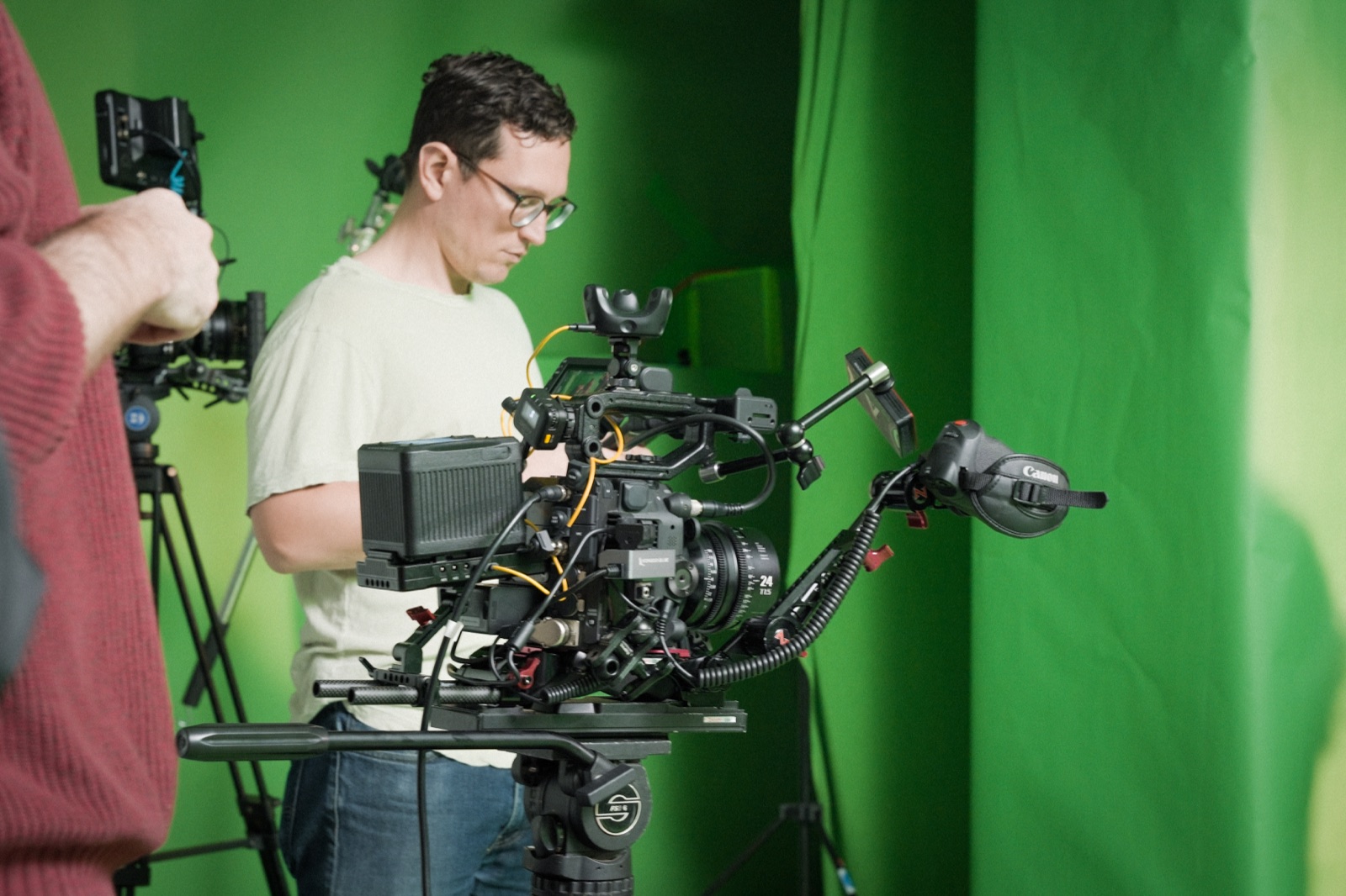 Camera operator setting up a cinema camera on set
