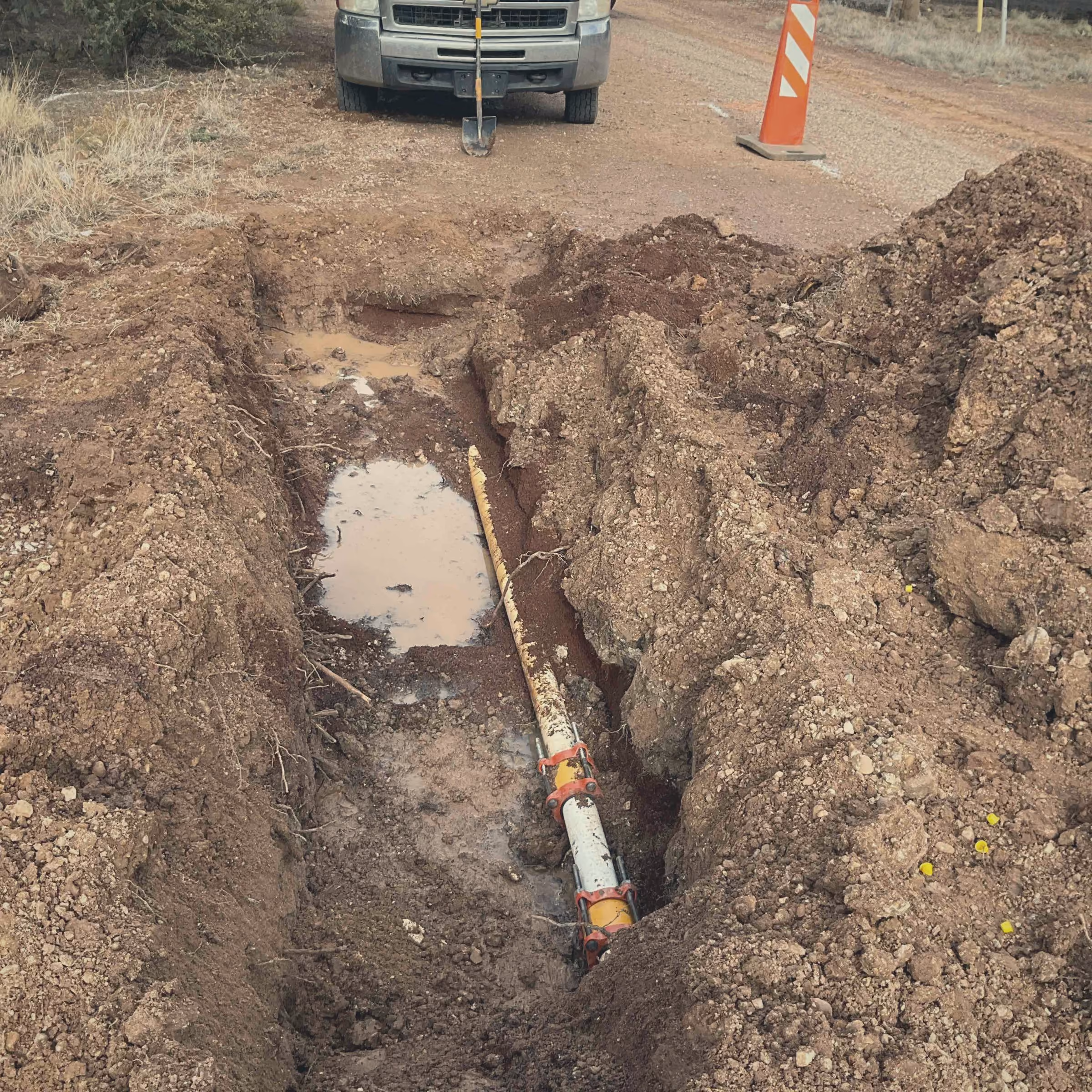Exposed collection main in an open roadside trench