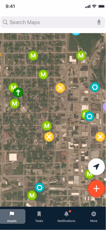 Mobile GIS Utility Mapping app screen showing a satellite map with multiple green M markers, orange X markers, blue hexagon icons, and navigation controls, with a bottom menu including Assets, Tasks, Work Orders, Notifications, and More. Ziptility is software for water and wastewater utilities. Asset Management, GIS, Tasks, Work Orders, Preventative Maintenance all in on place.
