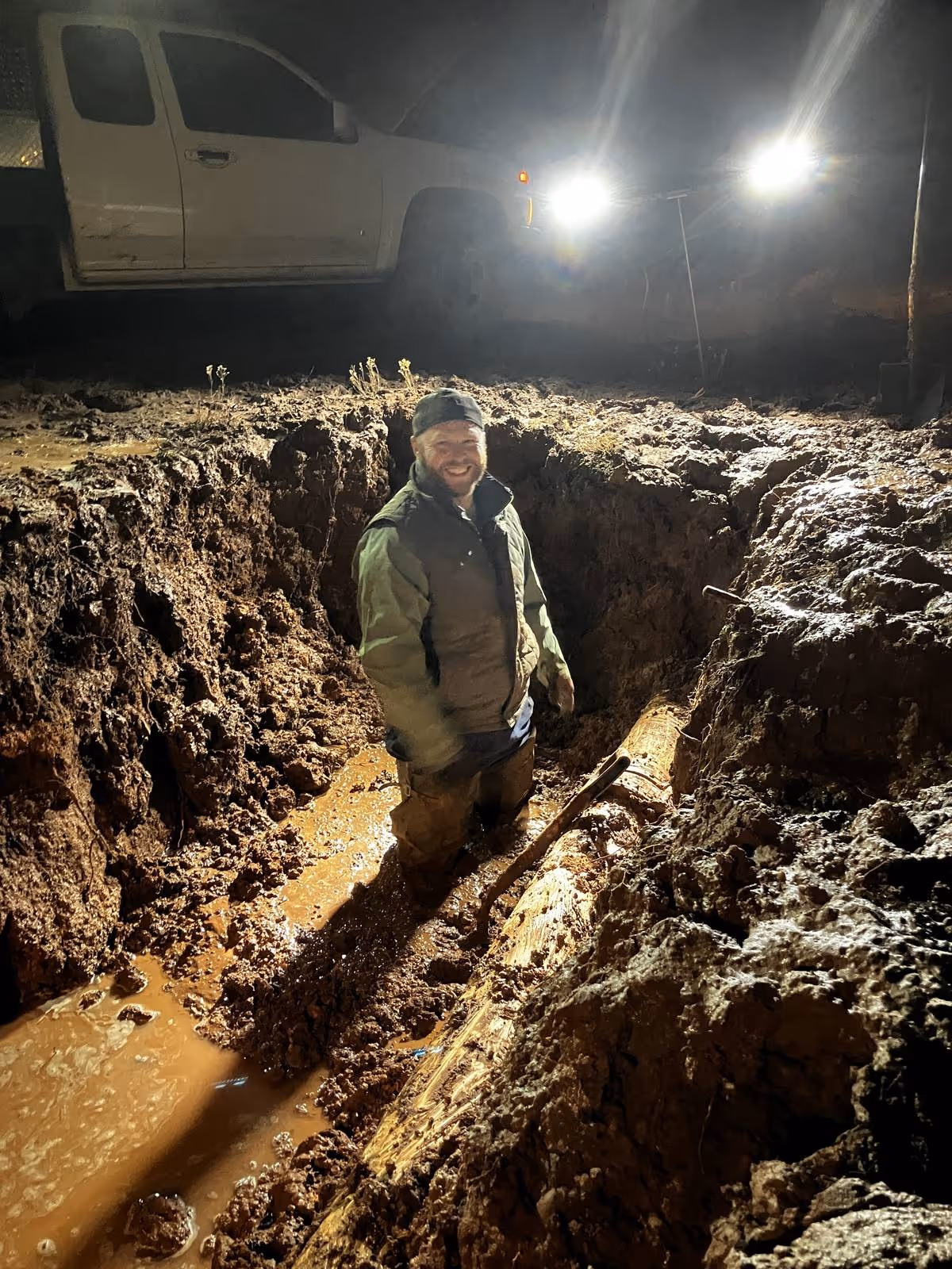 Water utility operator working in a trench at night — the knowledge that walks out the door when they leave