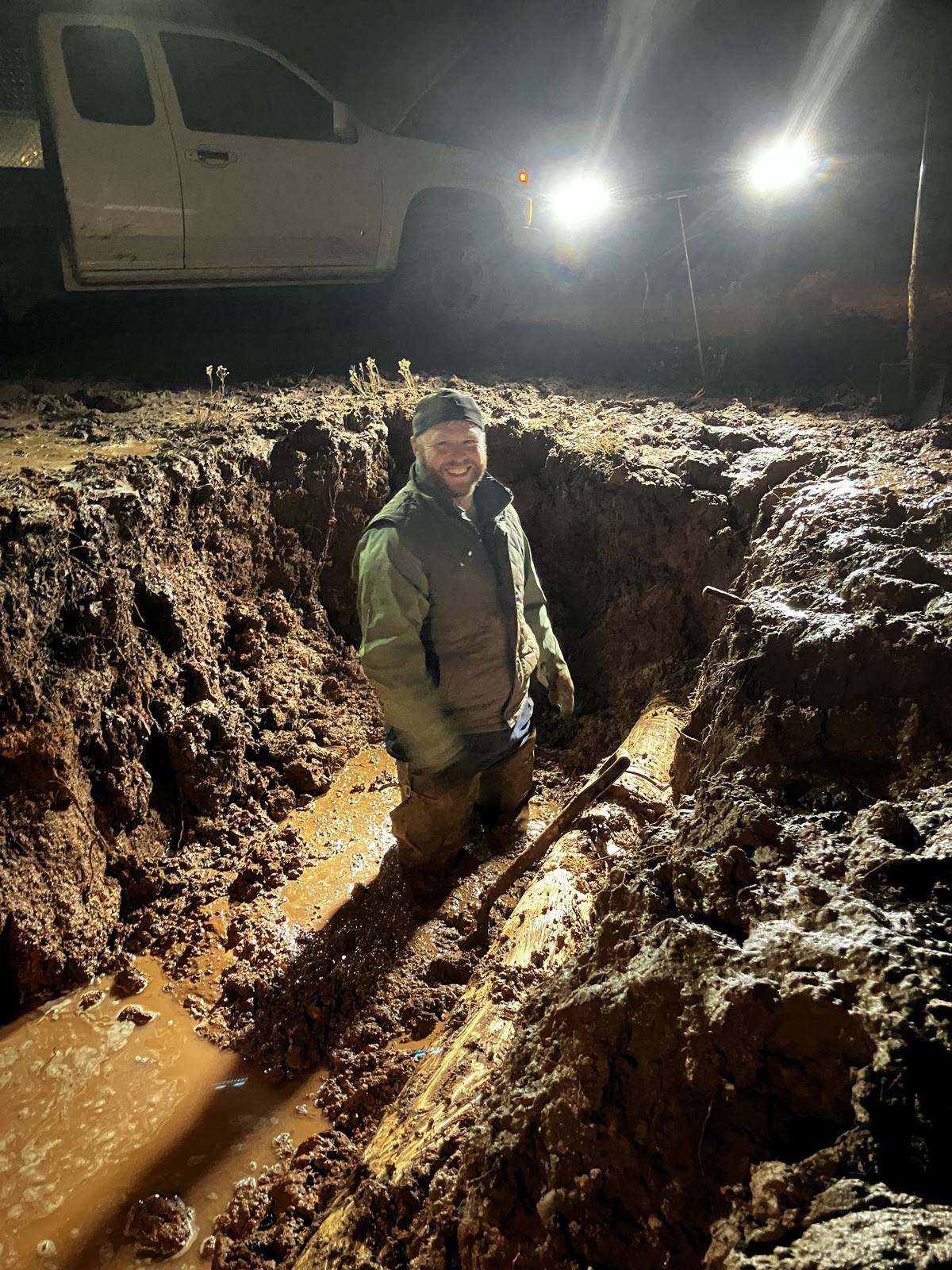 Water utility operator working in a trench at night — the knowledge that walks out the door when they leave