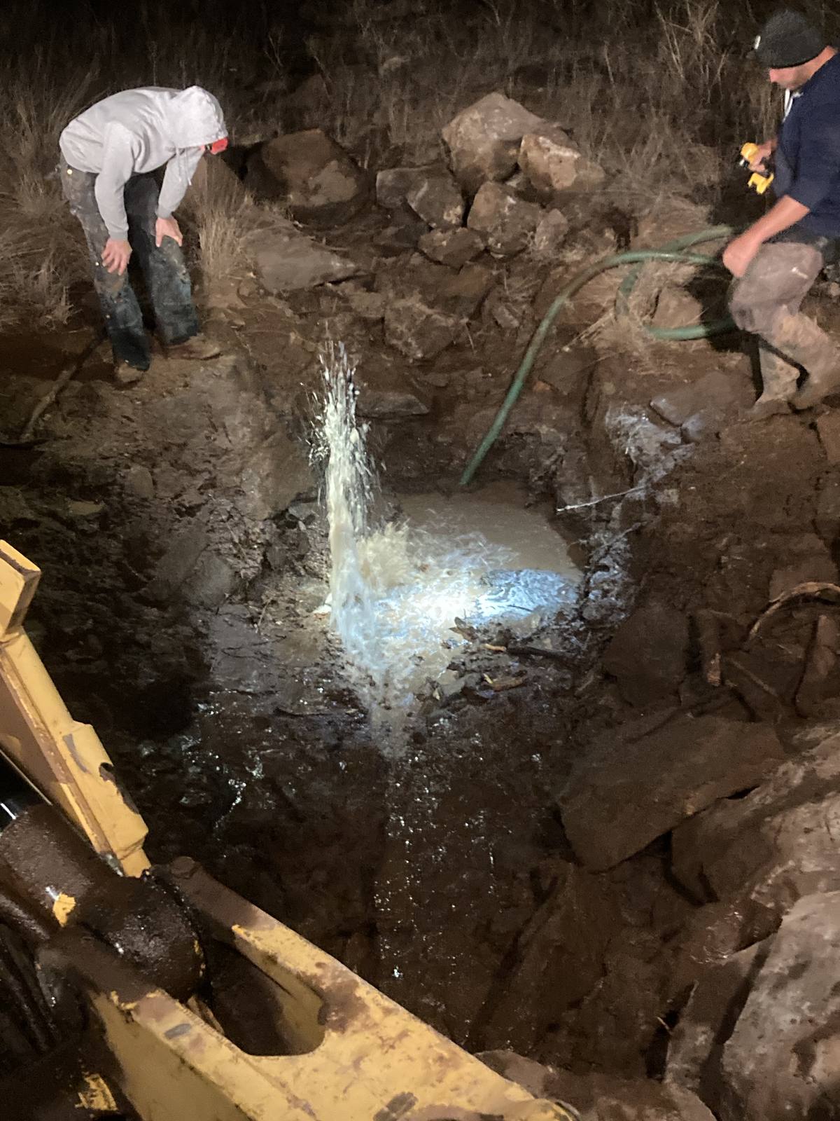 Operator responding to a flooded utility pit at night — the urgency that requires fast tools and teamwork