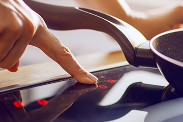 a finger pressing a button on a touch screen