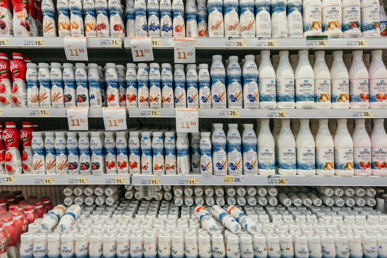 a shelf with white bottles and labels
