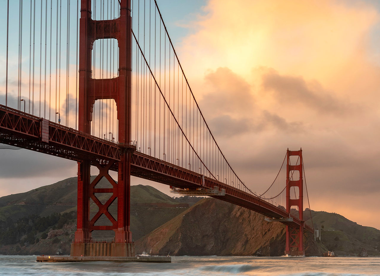 a large red bridge over water
