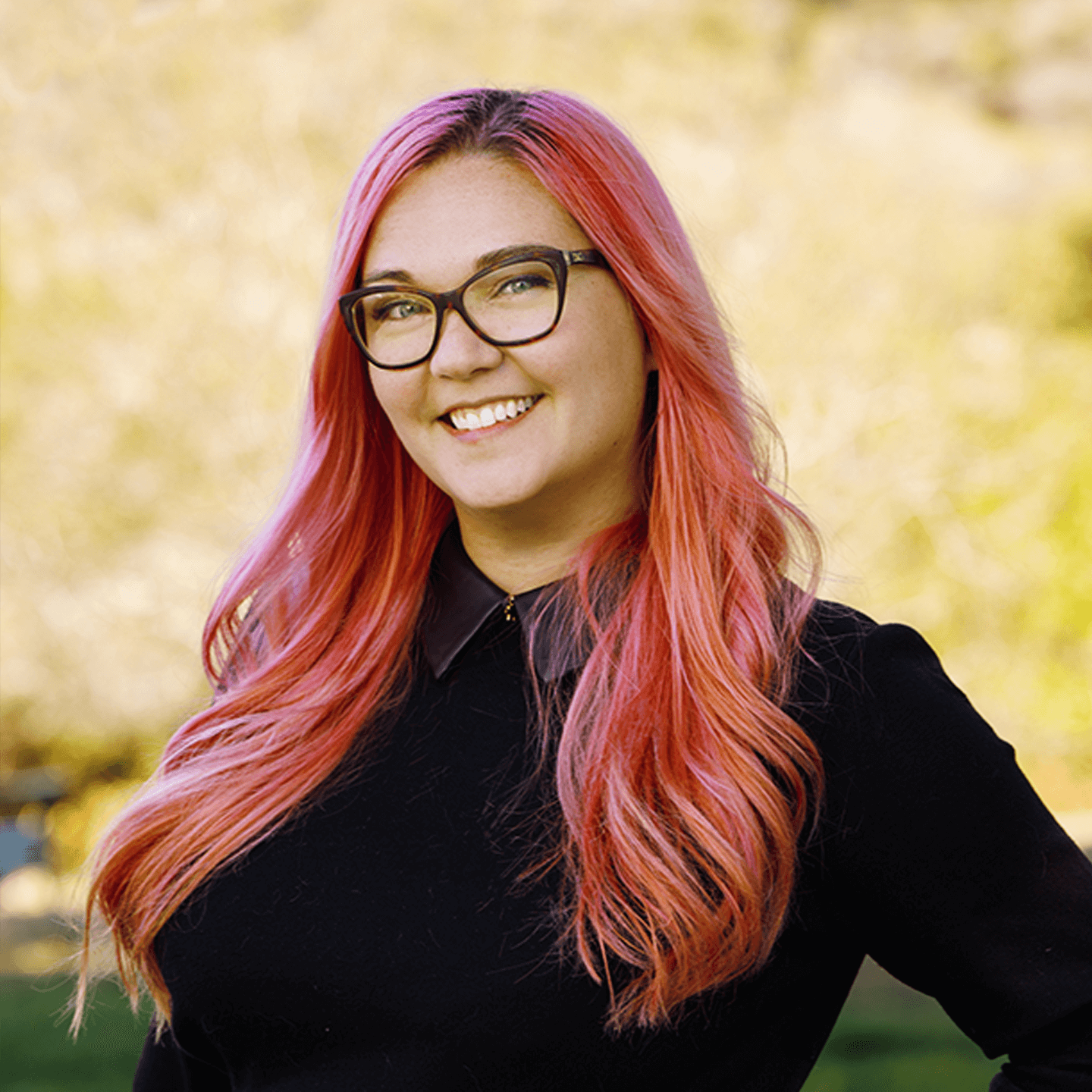 a woman with pink hair smiling