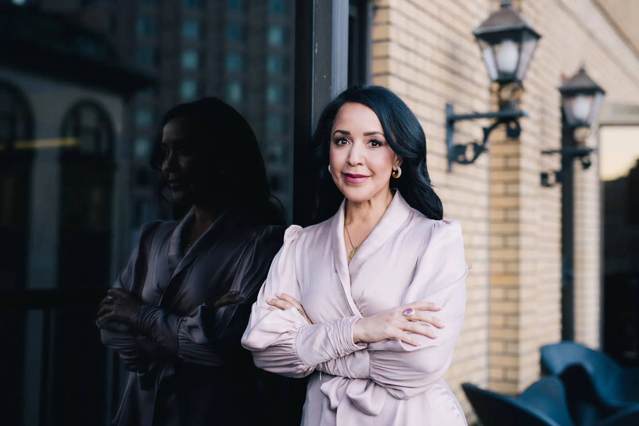 a woman standing next to a window