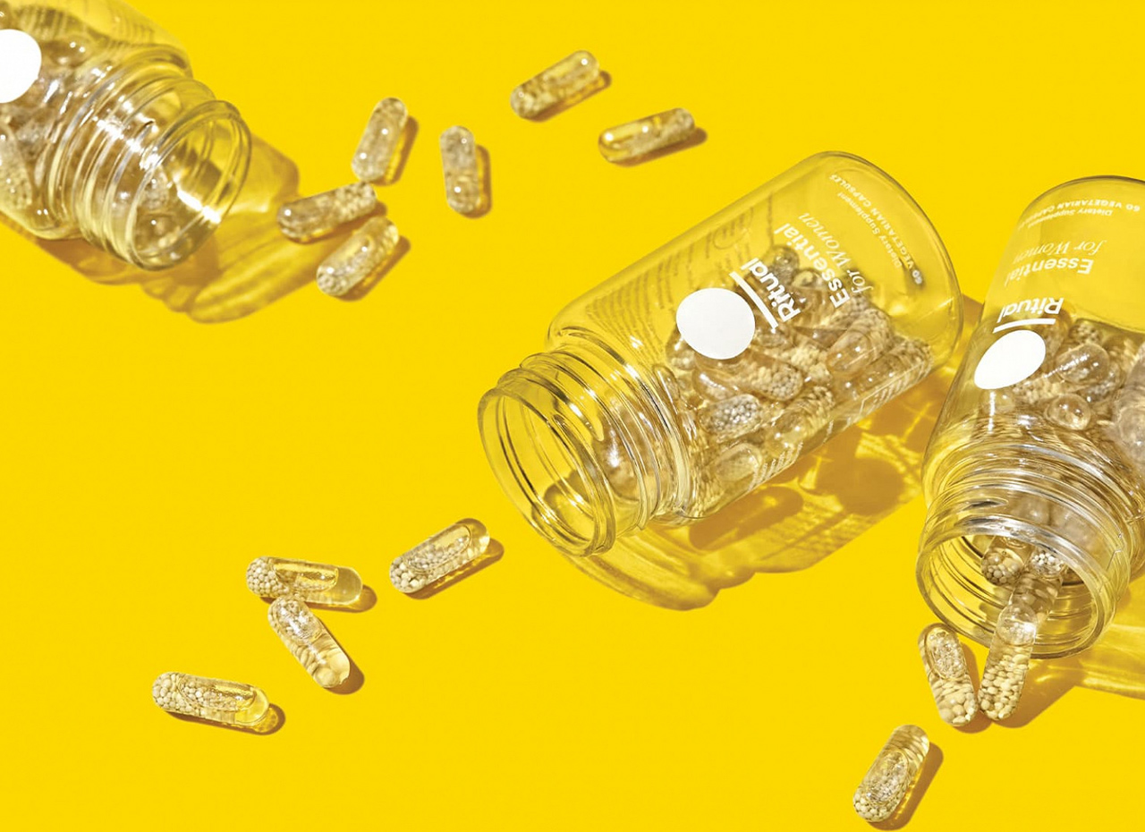a group of transparent pills spilling out of a jar