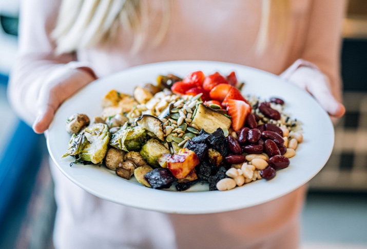 a plate of food with a person holding it