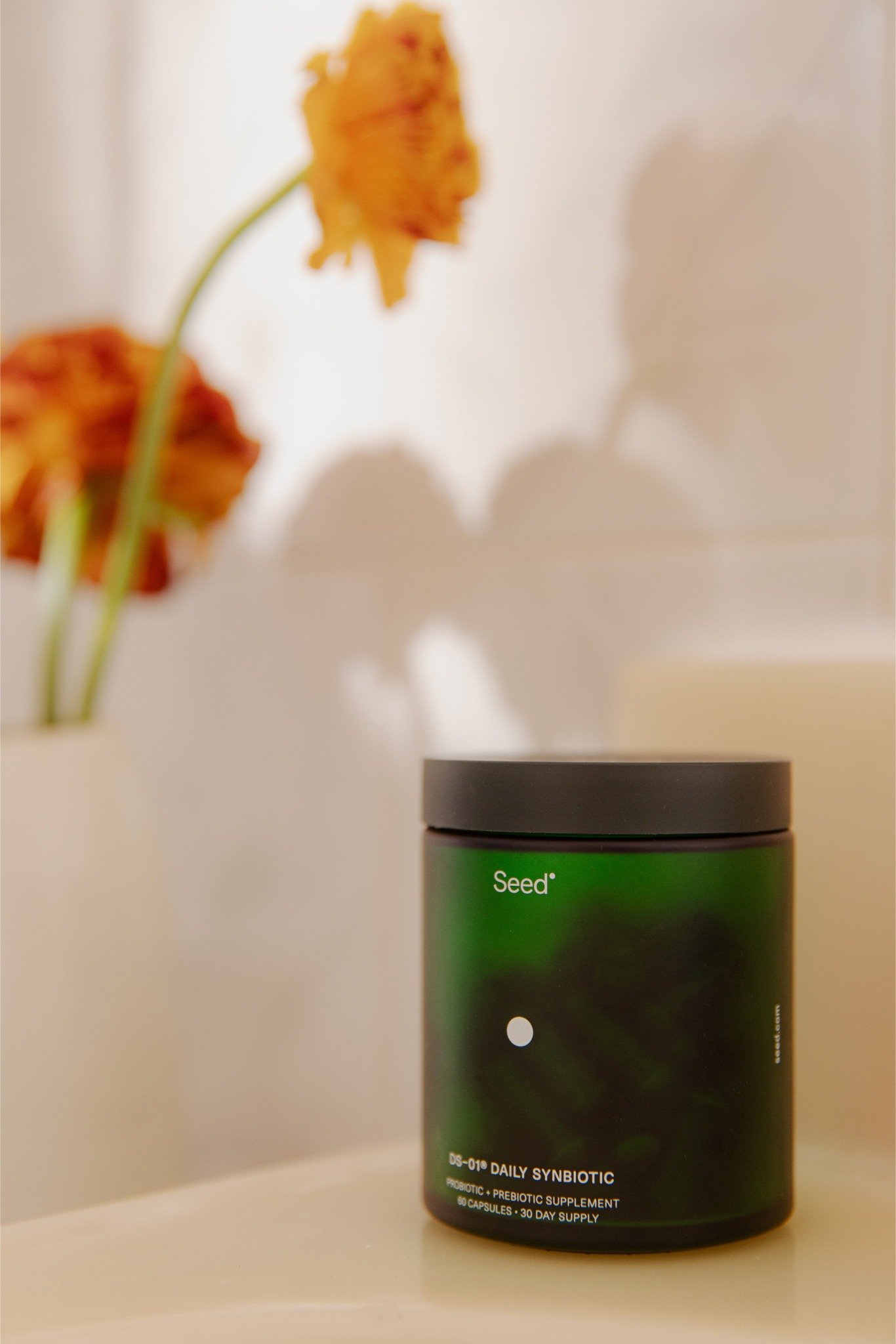 a green container with a black lid