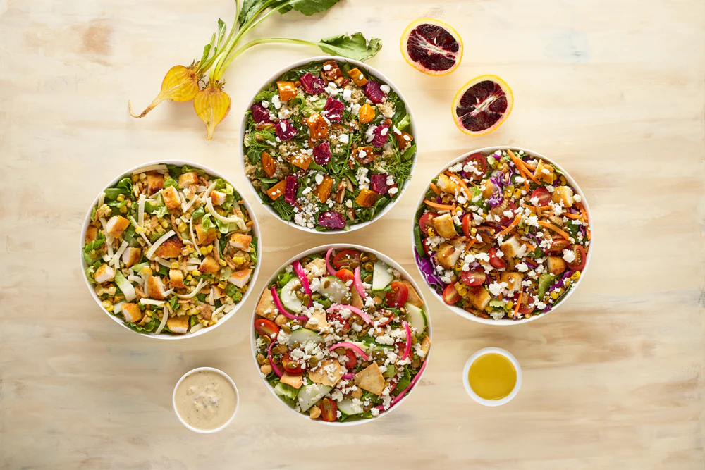 a group of bowls of salad