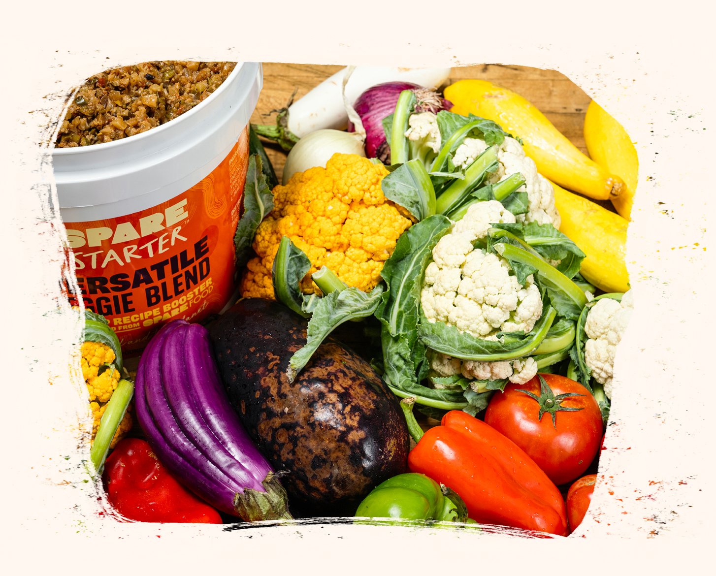 a pile of vegetables and a bucket of food