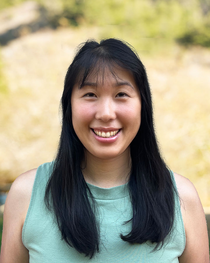 a woman with long black hair smiling