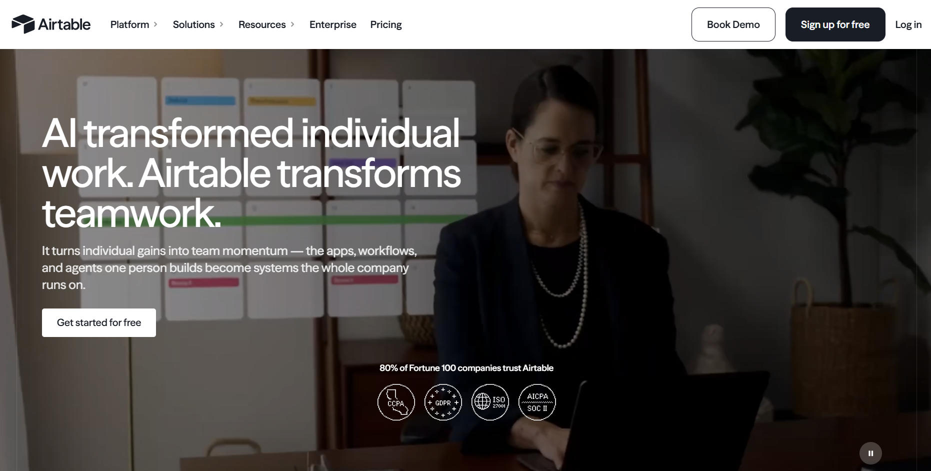 Airtable homepage promoting AI-powered collaboration, workflow automation, enterprise work management, database-driven applications, security certifications, and Get Started for Free and Book Demo buttons.
