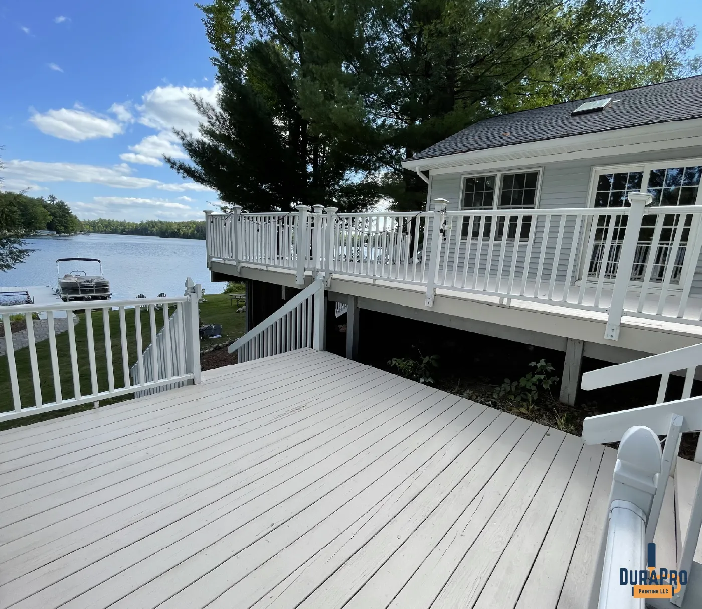 Grey deck overlooking a lake in Michigan that was recently stained by DuraPro Painting