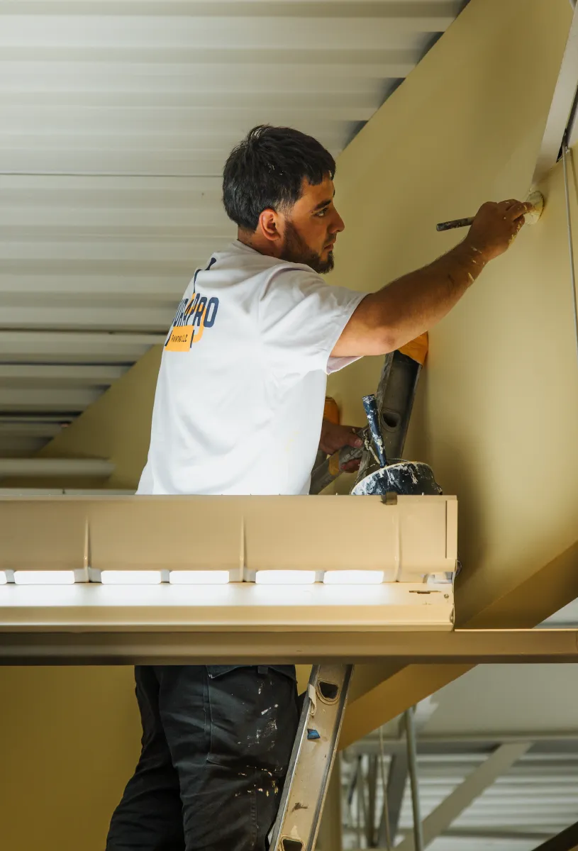 DuraPro Painting employee painting the interior of a commercial project.