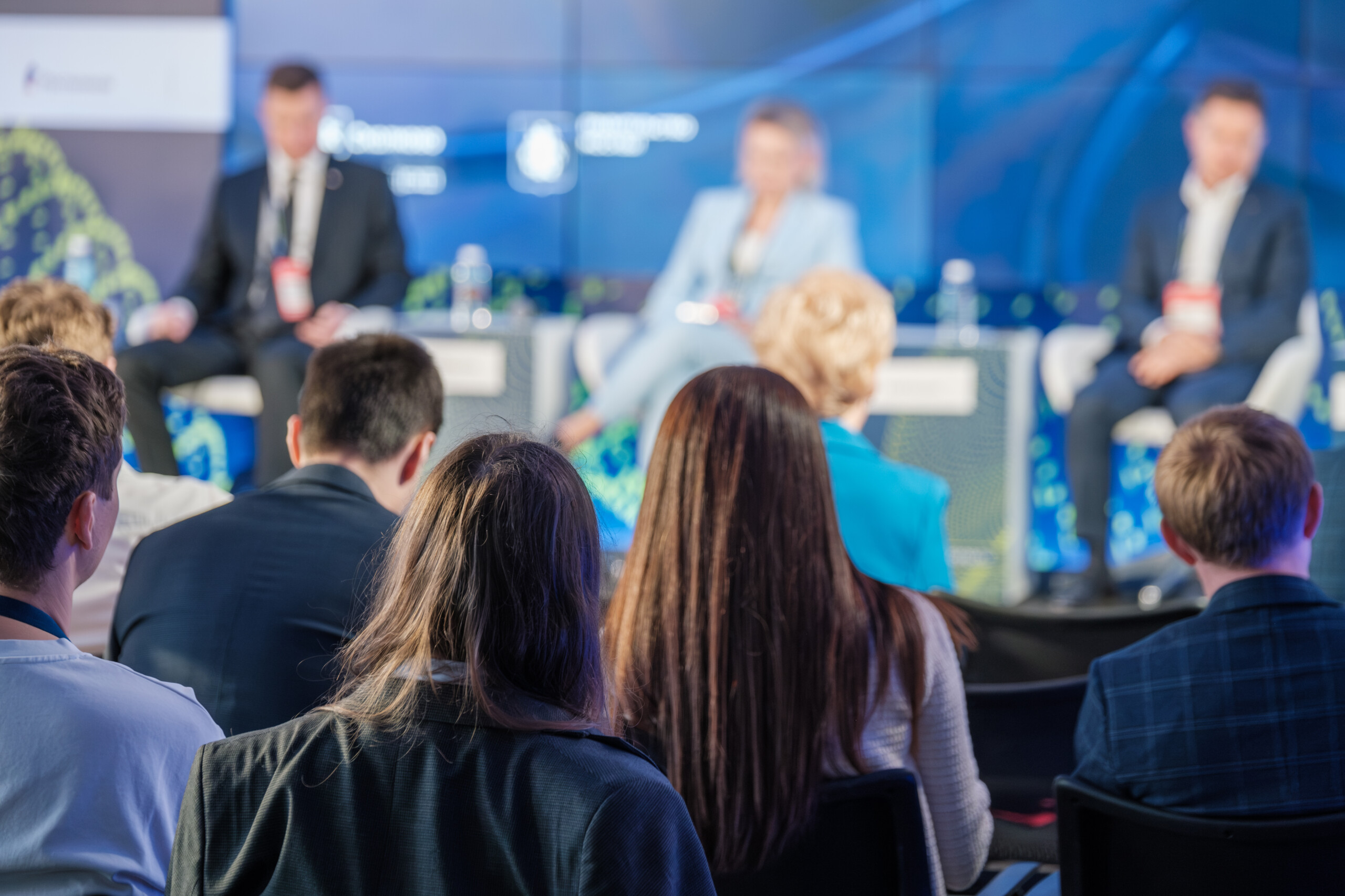An audience watching a panel discussion, from the Chamber event page.