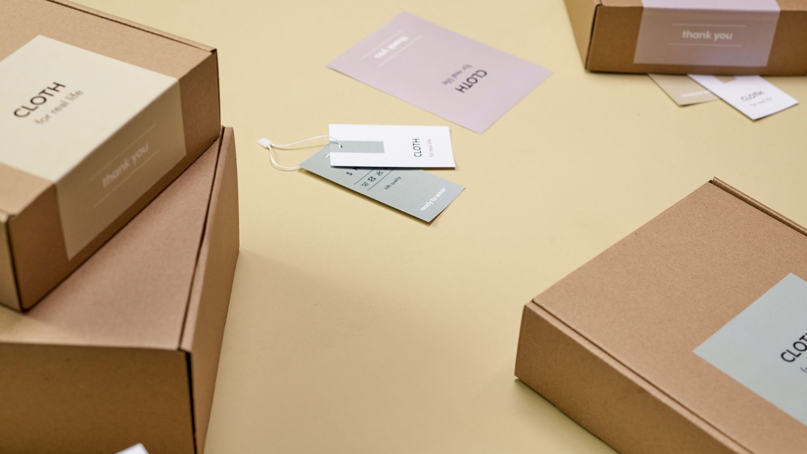Branded ecommerce shipping boxes and packaging laid out on a plain background
