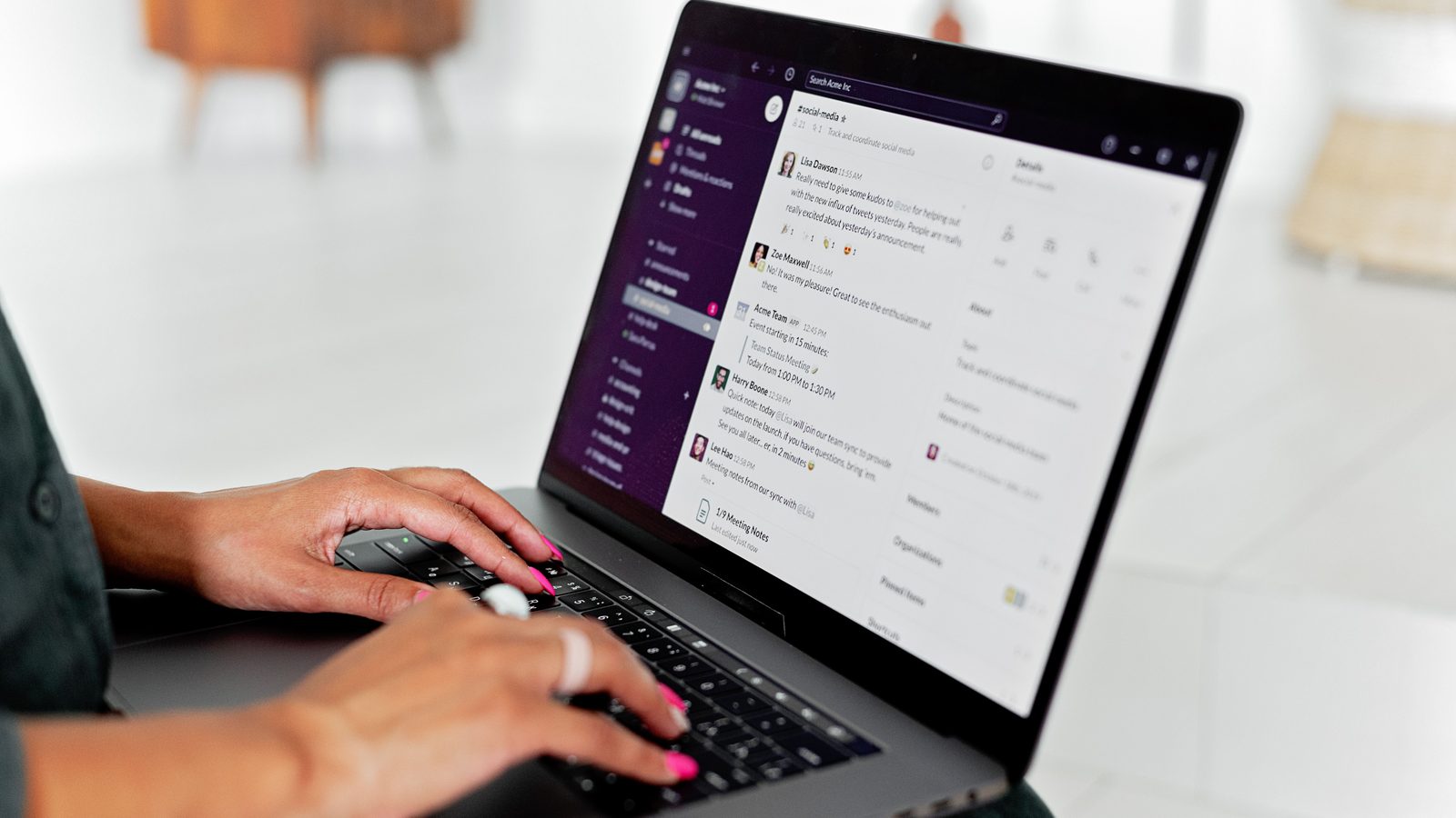 Person using laptop chat interface office.