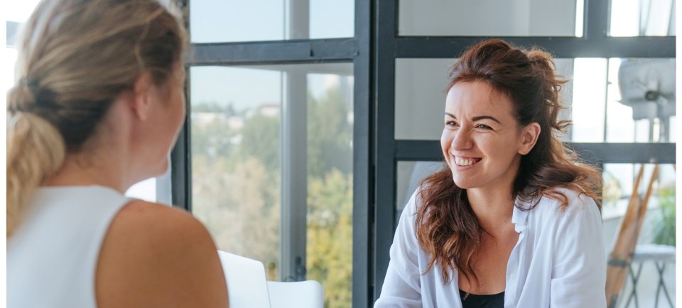 A Kitchen Studio designer having an in-home consultation with the lady homeowner