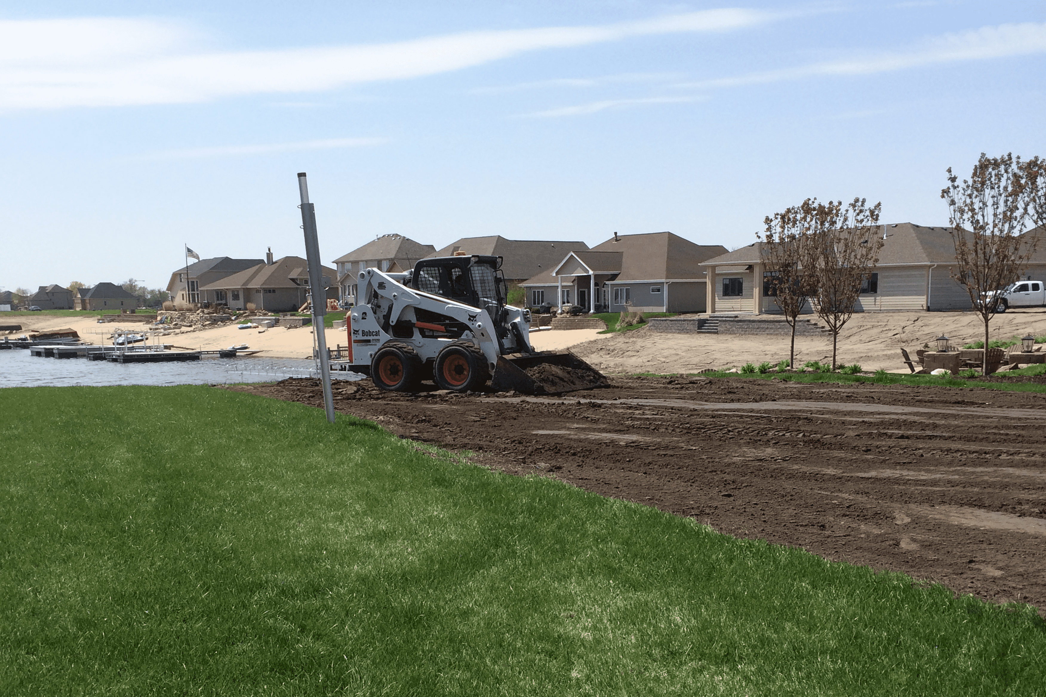 Nick's Lawn Care skid loader completing heavy equipment project work